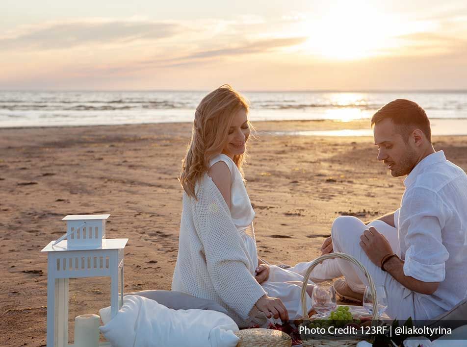 couple enjoying a romantic afternoon tea on beach - Grand Lexis PD
