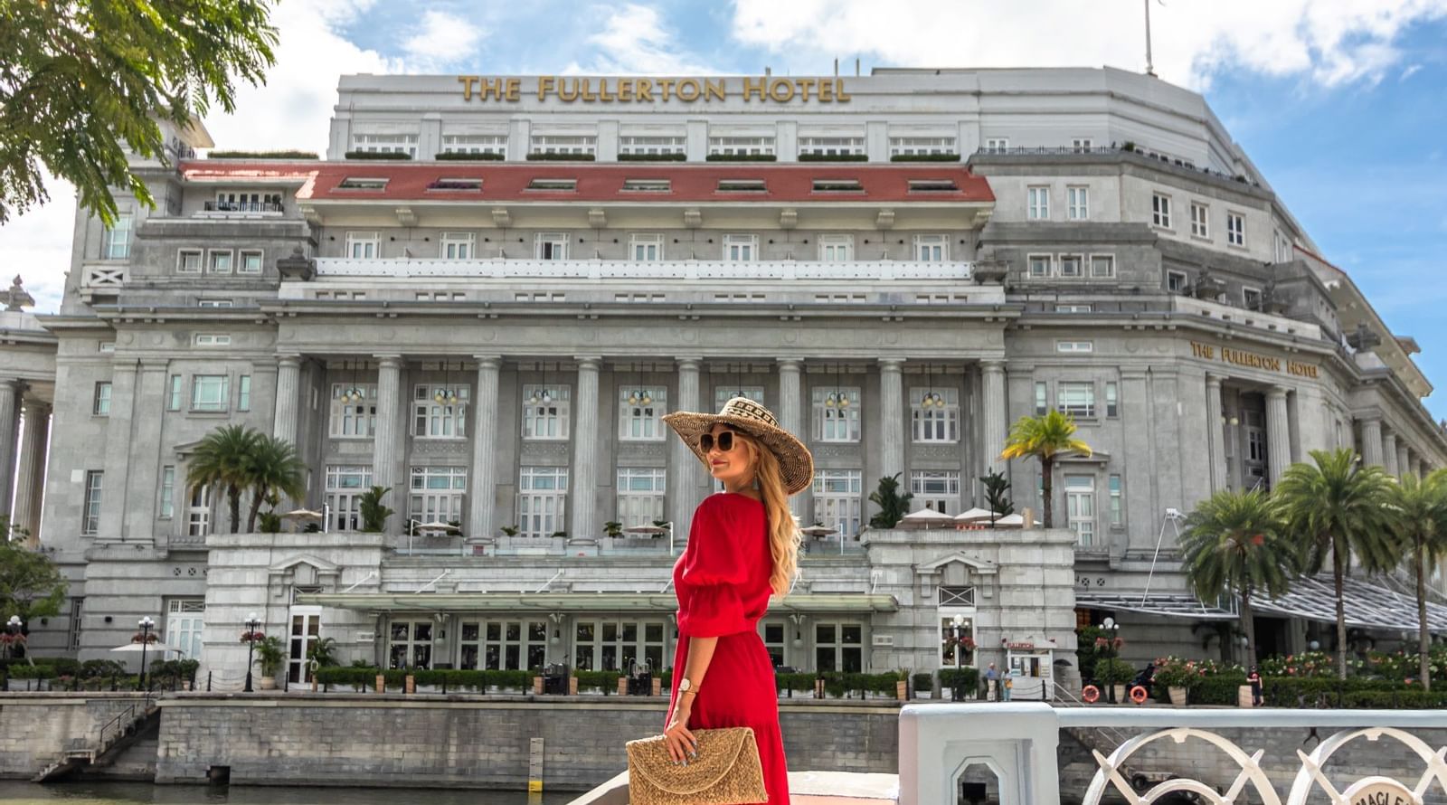 A lady in red posing at the entrance of Fullerton Singapore