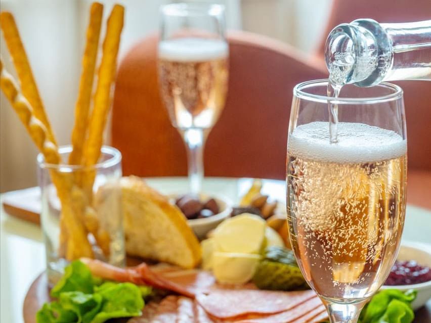 Close-up of pouring champagne to a glass at Hotel Grand Chancellor