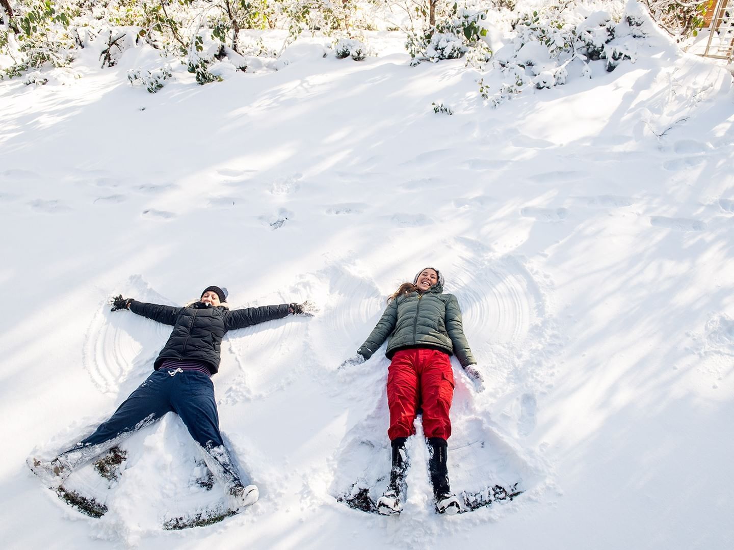 Two children having fun on snow at Cradle Mountain Hotel