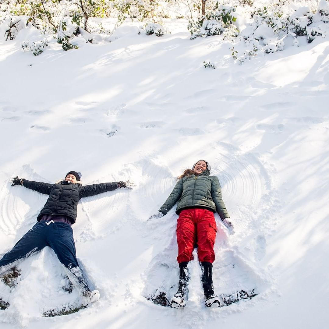 Two children having fun on snow at Cradle Mountain Hotel