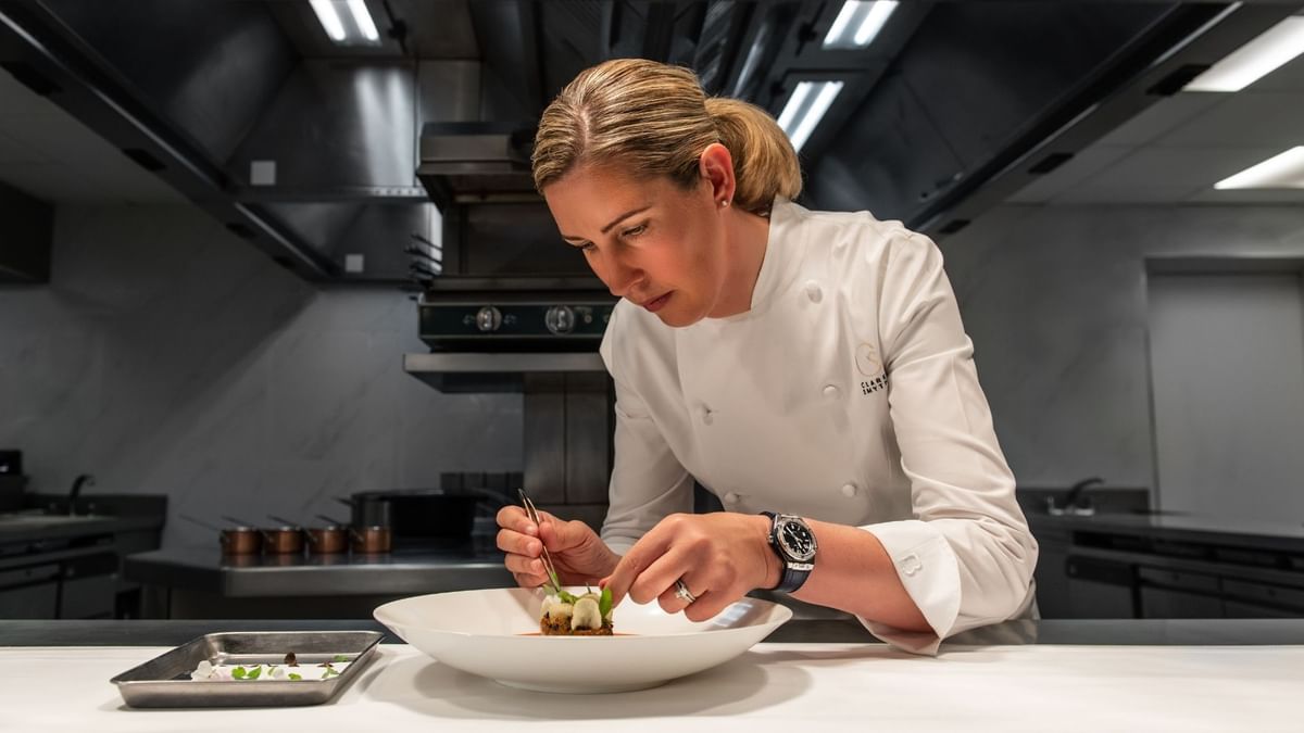 A chef lady garnishing a dish at Crown Towers Sydney
