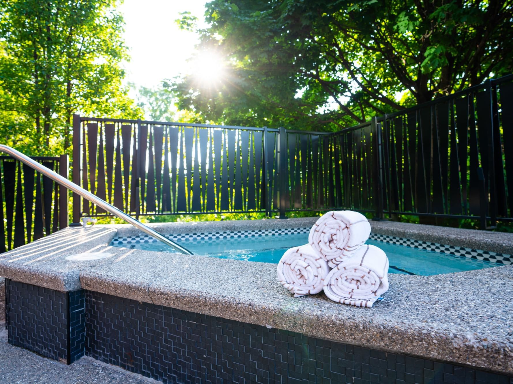 Towel rolls by the outdoor hot tub with a garden view at The Earl