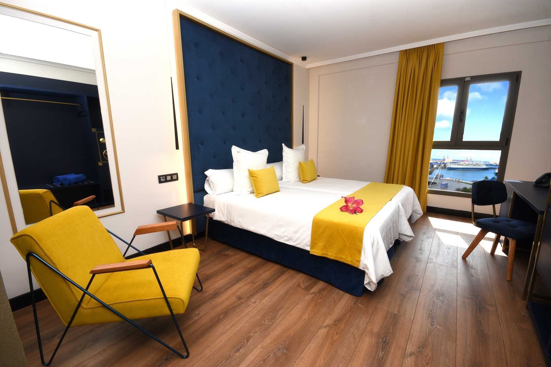 A flower on a bed in a room at Design Plus Group Hotels