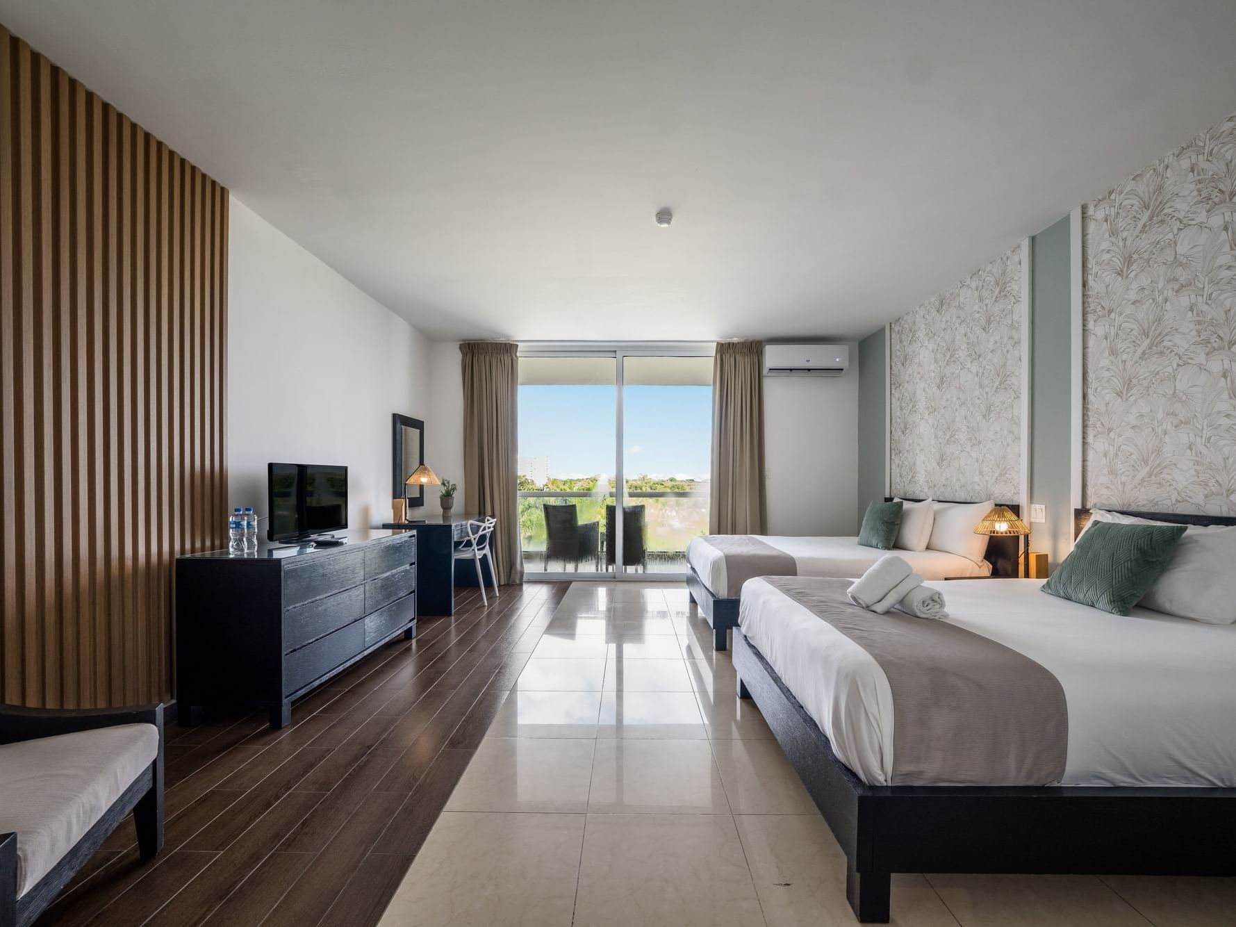 Spacious Luxury Suite with two beds, balcony, and modern decor at Playa Blanca Resort in Rio Hato.