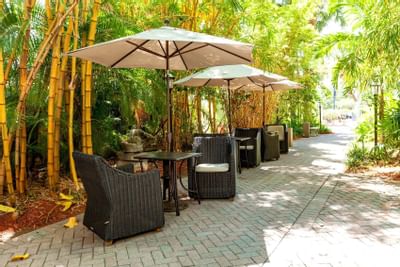 outside dining tables under umbrellas
