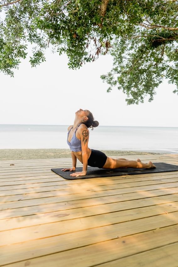 Woman doing yoga at the deck