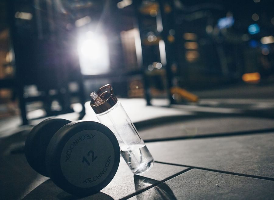 Close-up of a dumbbell and water bottle in gym at The May Fair Hotel