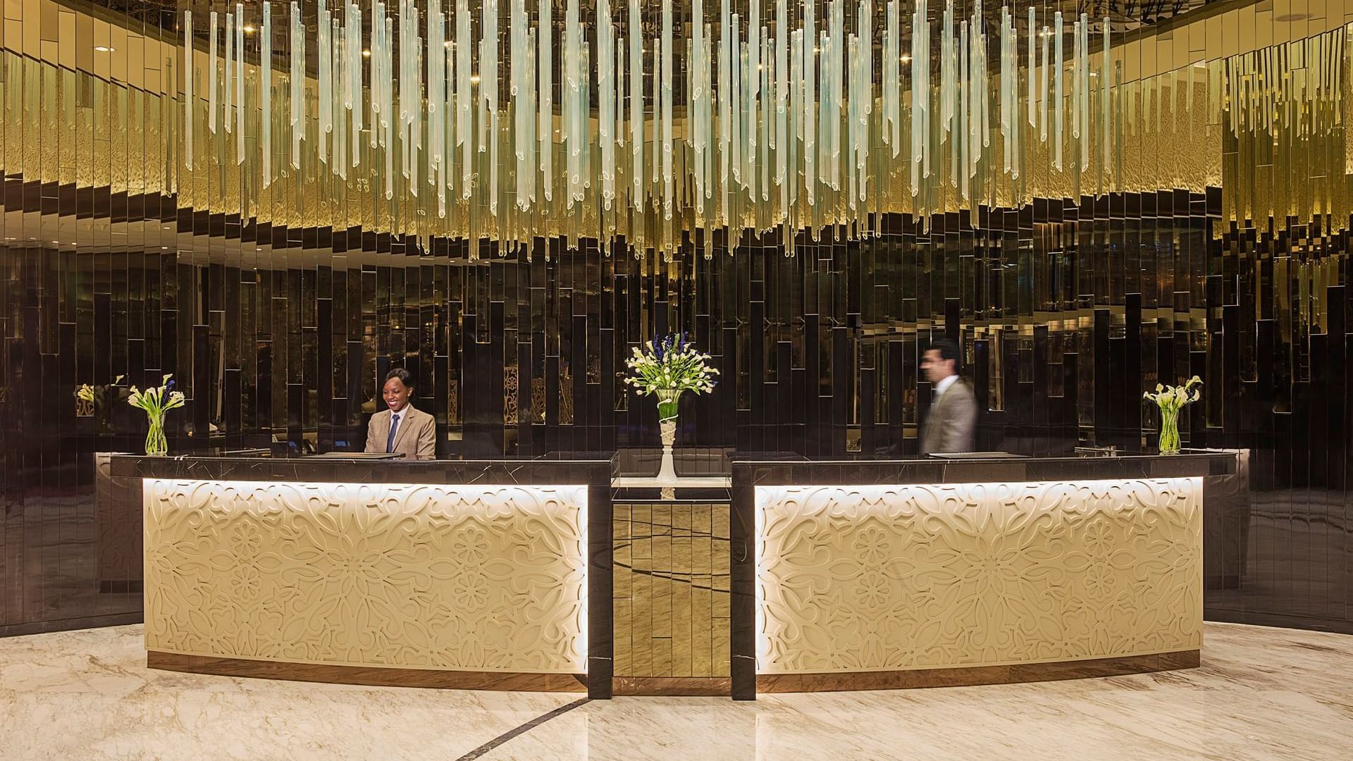 Welcome receptionist counter area in the hotel lobby lounge area at DAMAC Maison Distinction