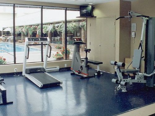 fitness center with view of outdoor pool