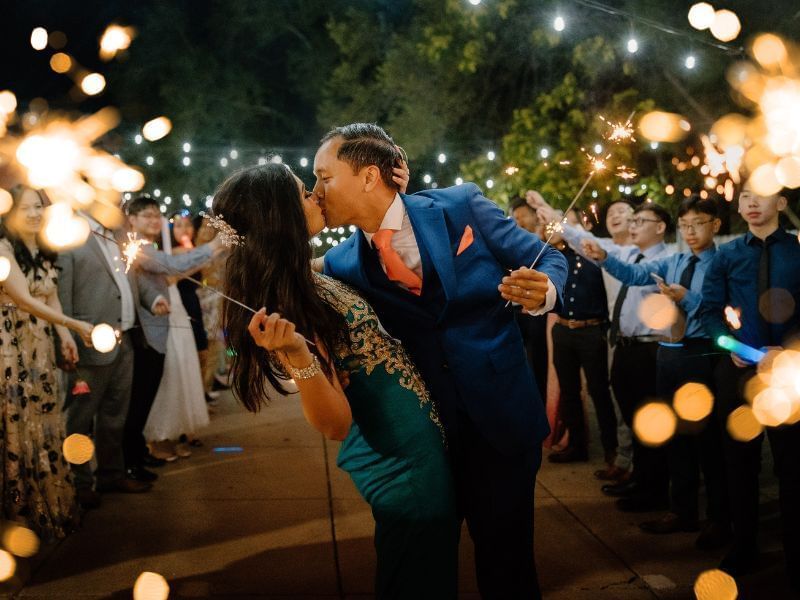 Couple kissing surrounded by sparklers at The Vail