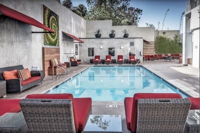 Outdoor pool area with lounge beds at Hotel Angeleno
