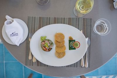 Aguachile La Ceiba dish with a wine glass served at Villa Premiere Boutique Hotel & Romantic Getaway