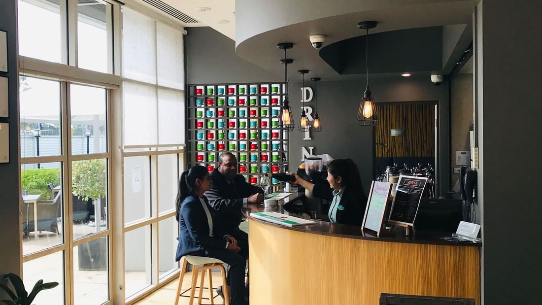 A couple served wine at M Bar & Terrace Mercure Sydney Parramatta