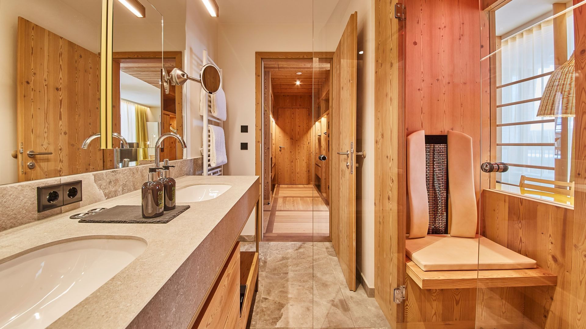 Bathroom vanity & chair in Loft Suite at Falkensteiner Hotels
