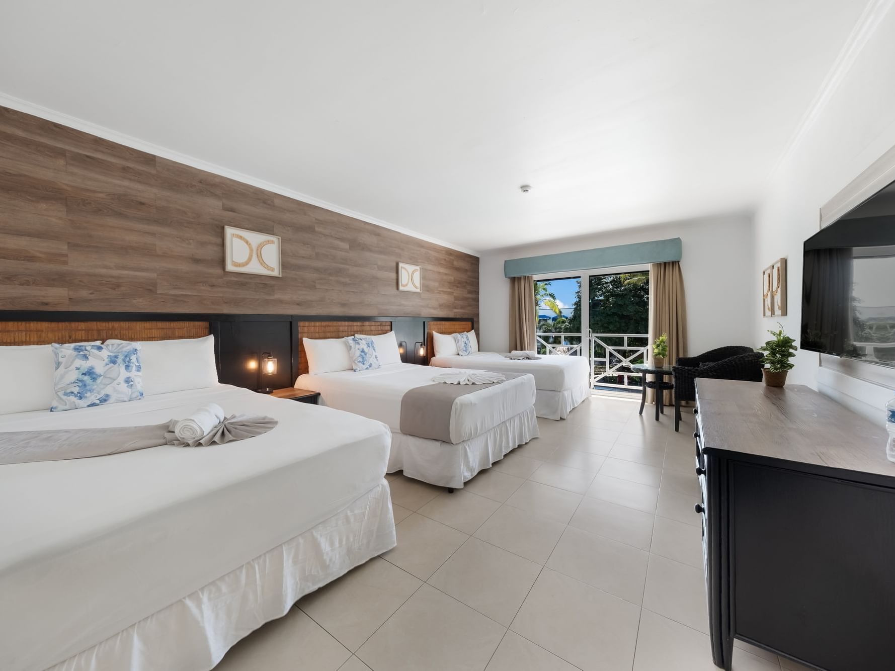 Family Room with two beds, balcony with ocean view, and modern amenities at Playa Blanca Resort in Rio Hato.