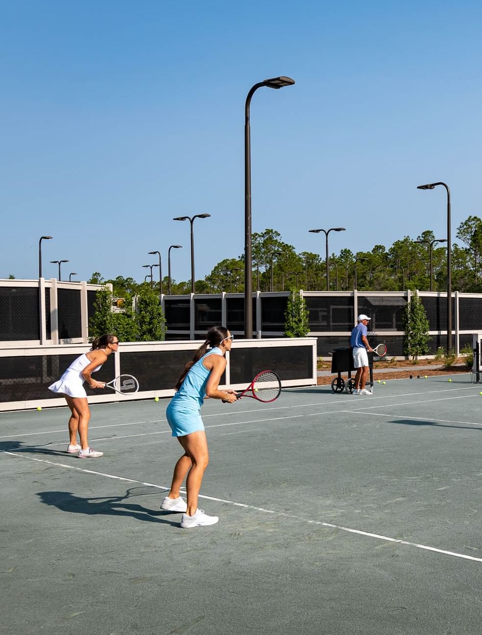 Girls wearing sportswear playing Tennis in a court at Camp Creek Inn