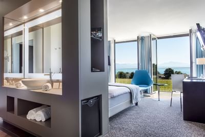 Superior Room Bathroom vanity & interior overlooking the garden & Sea at Starling Hotel Lausanne accommodation