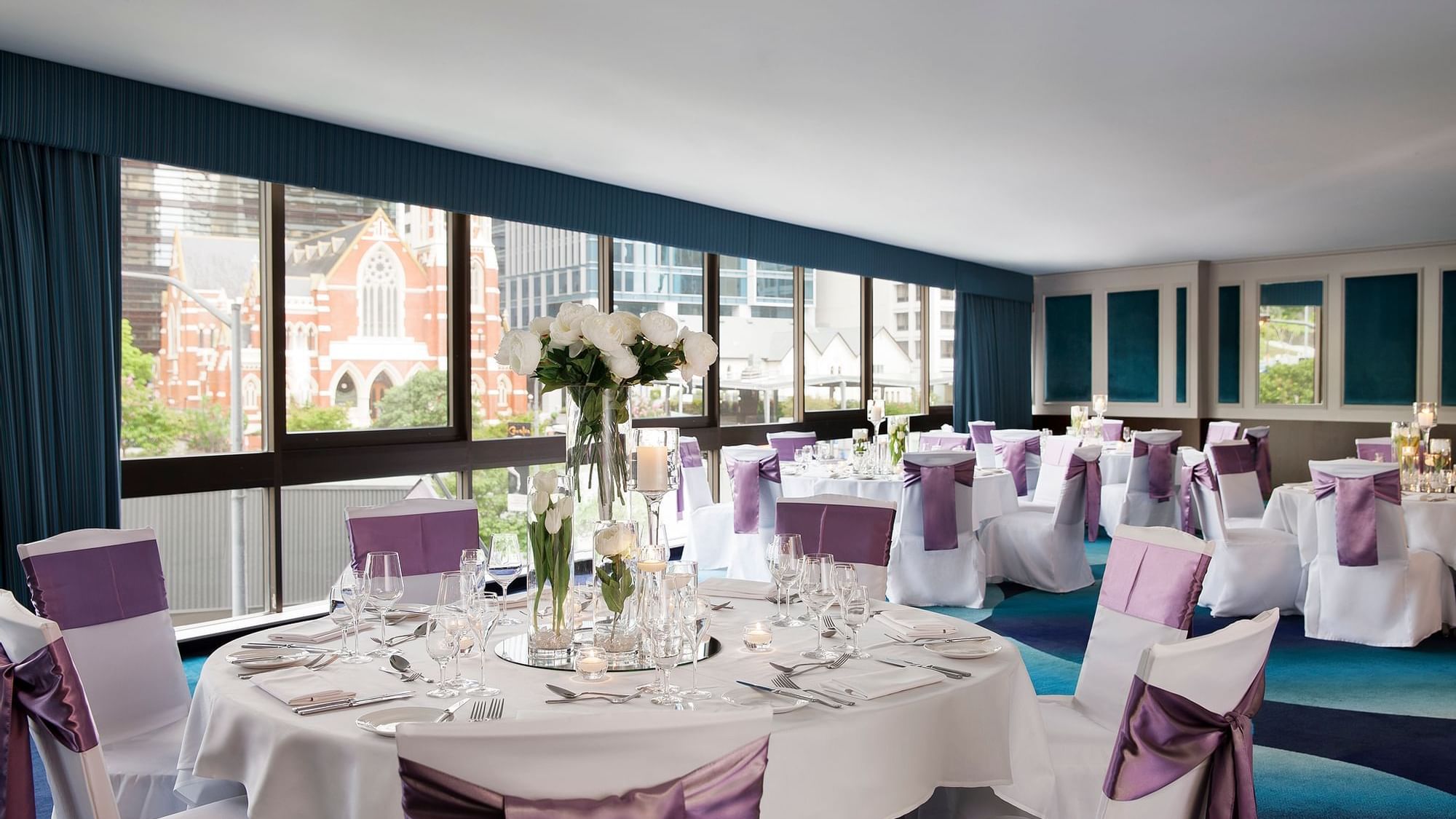 Banquet tables arranged with a city view in a Wedding venue at Pullman King George Square