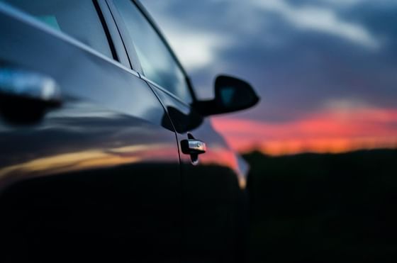 A parked car against a stunning sunset backdrop at Imperial Lexis Kuala Lumpur