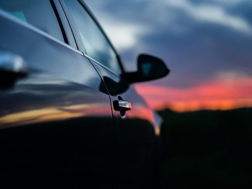 A parked car against a stunning sunset backdrop at Imperial Lexis Kuala Lumpur