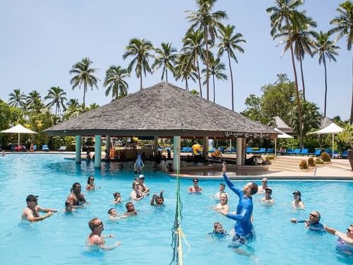 Group of people playing volleyball in the pool at The Naviti Resort - Fiji