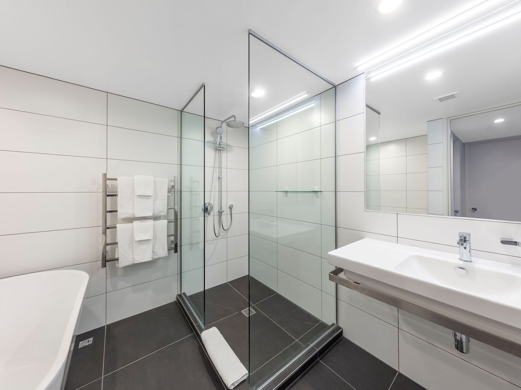 Bathroom shower & vanity area in a room at James Cook Grand Chancellor