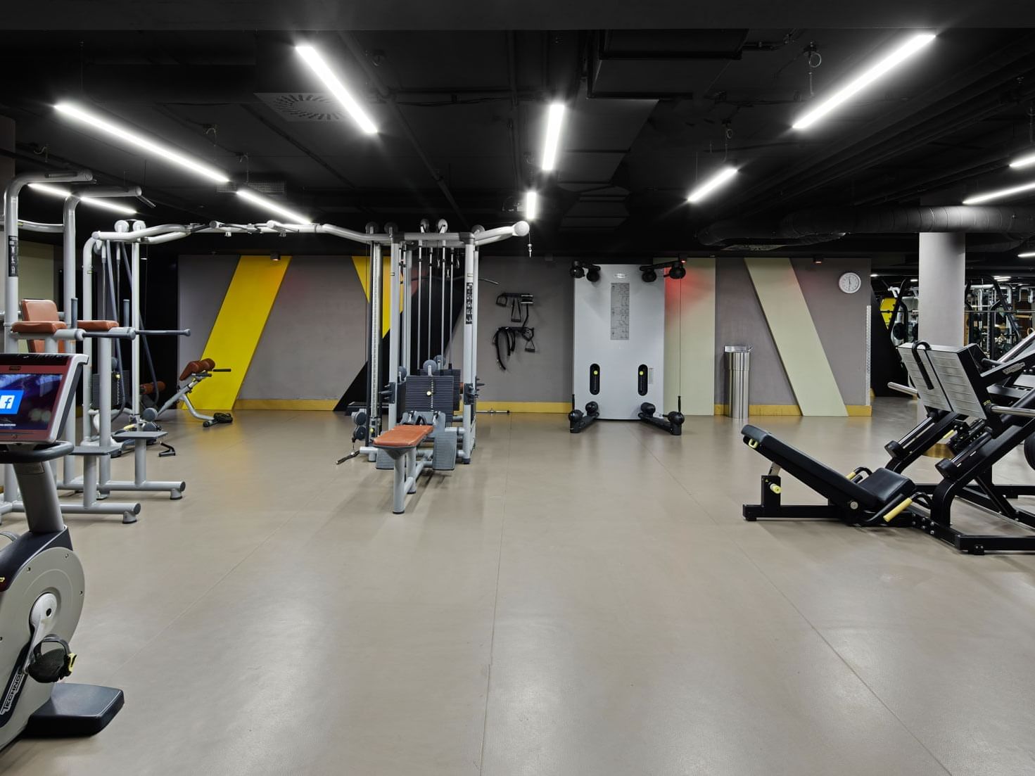 Moderner Fitnessraum mit Trainingsgeräten und heller Beleuchtung – Titanic Chaussee Berlin.