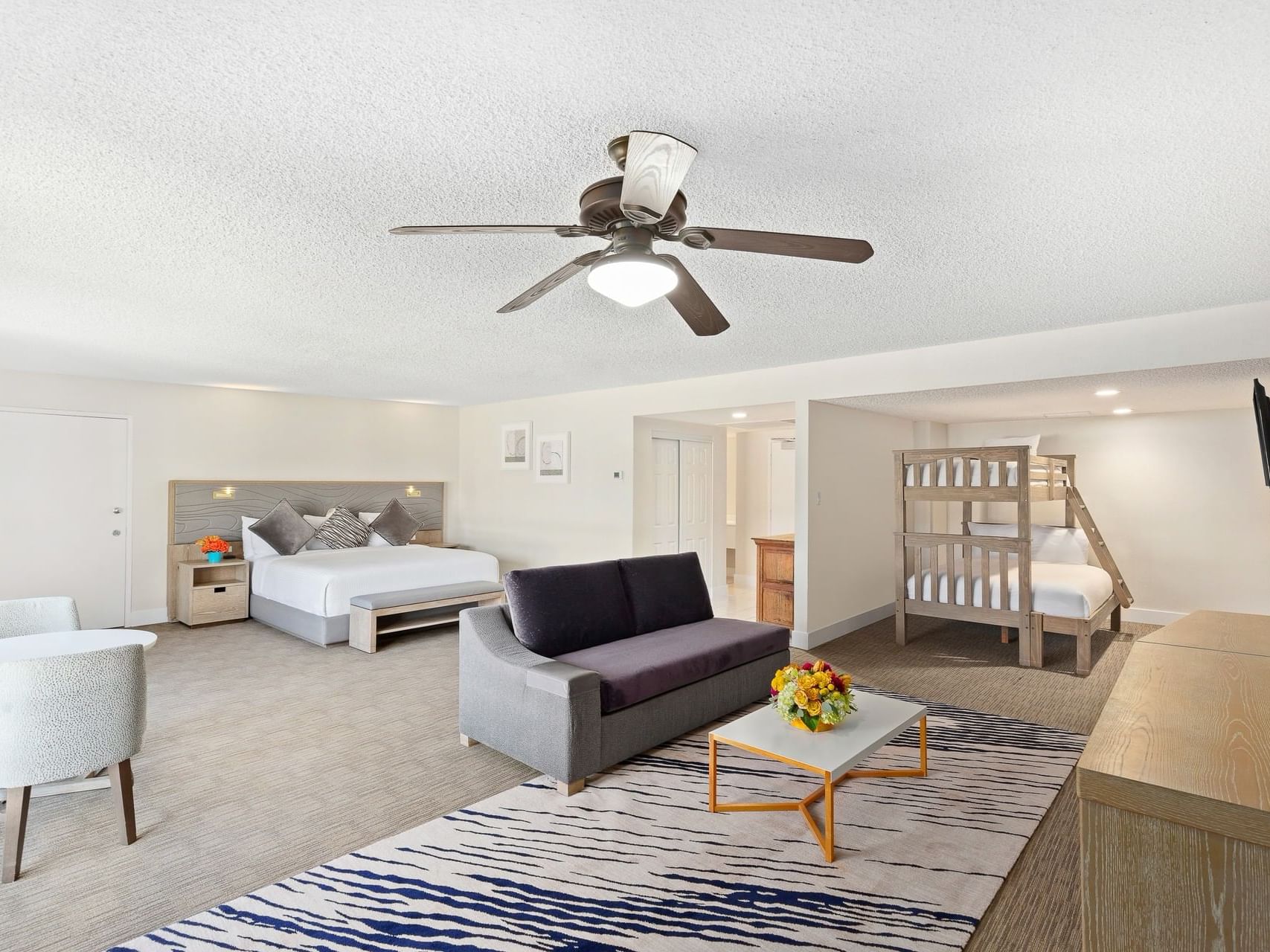 Comfy bed with living area in Kids Suite at The Anaheim Hotel