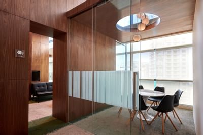 Boardroom table with chandelier at Tribeca Serviced Suites