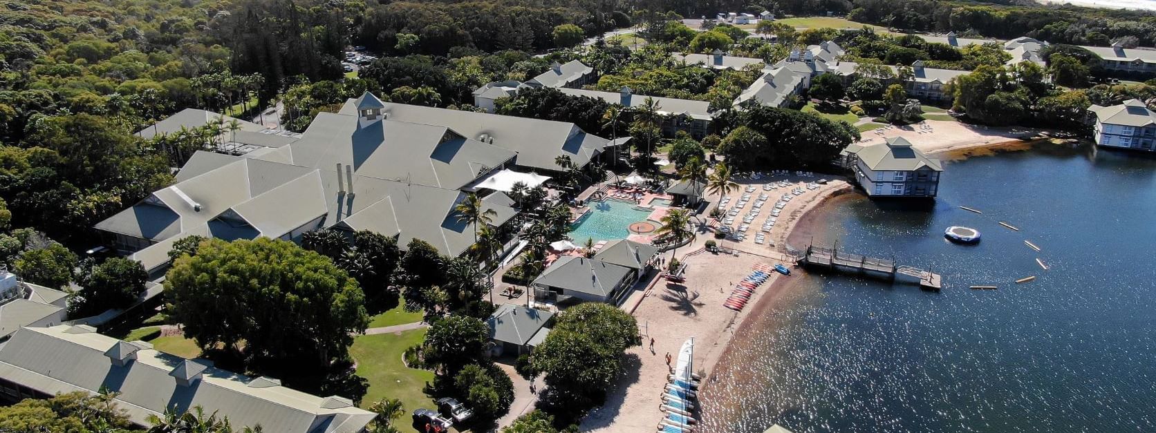 Aerial view of Novotel Sunshine Coast Resort with the pool facing the beachfront surrounded by tropical greenery