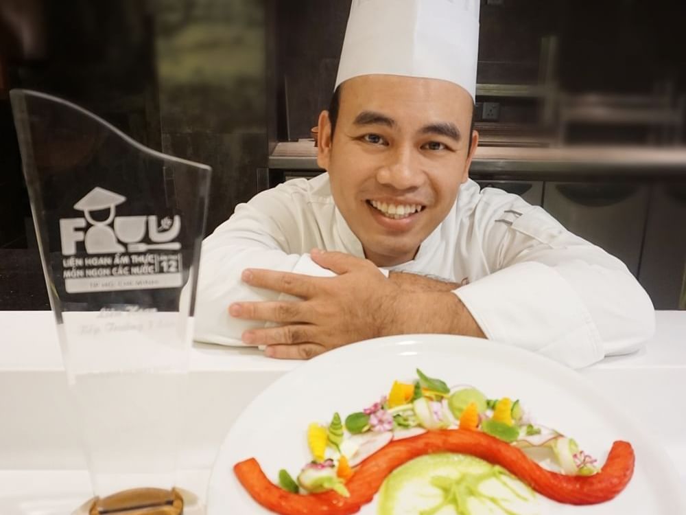 Chef Hoang Mai Tai posing with a dish at Eastin Grand Hotel Saigon