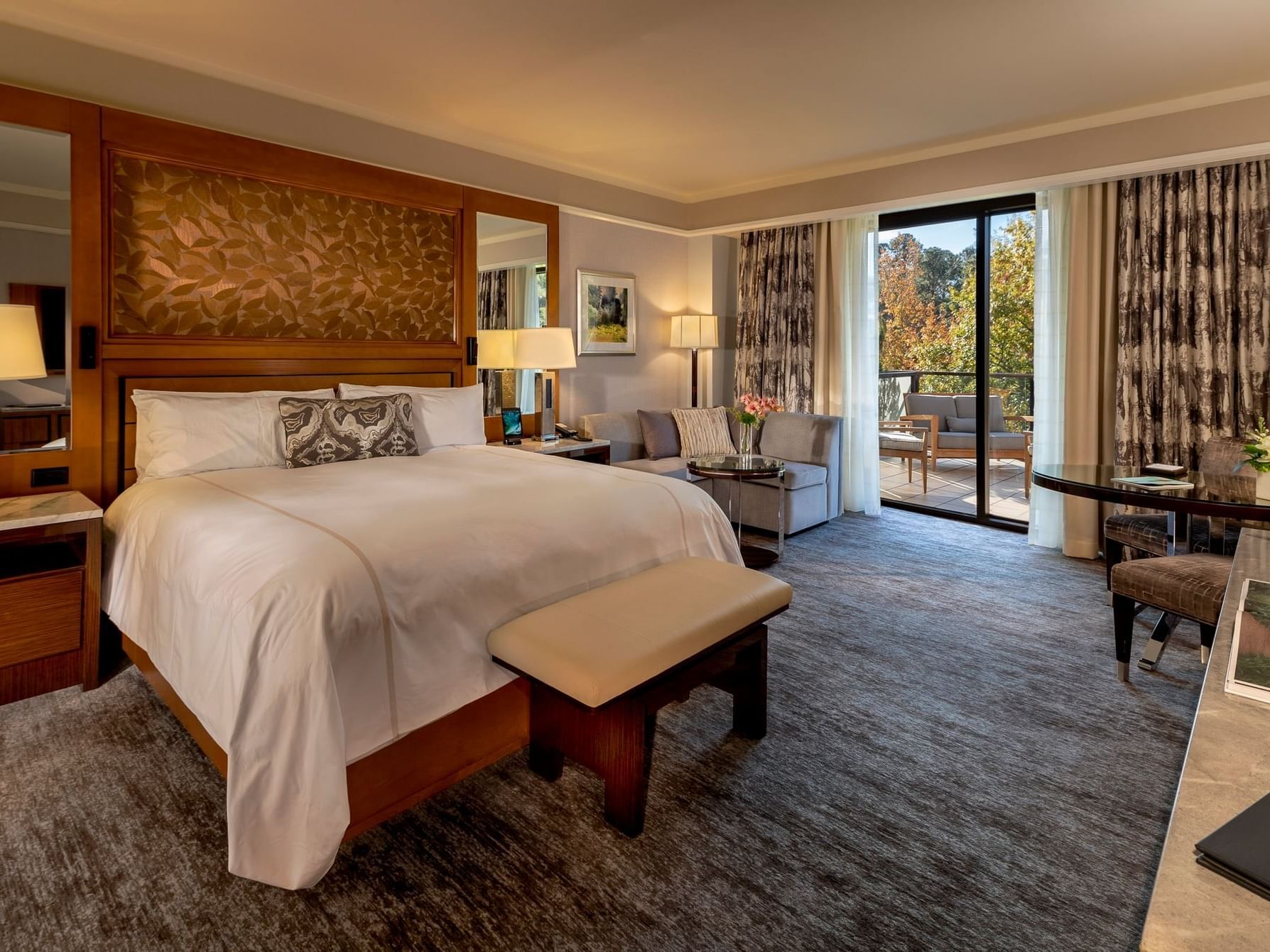 Comfy interior with carpeted floors in Superior Lake View Balcony King at The Umstead Hotel and Spa