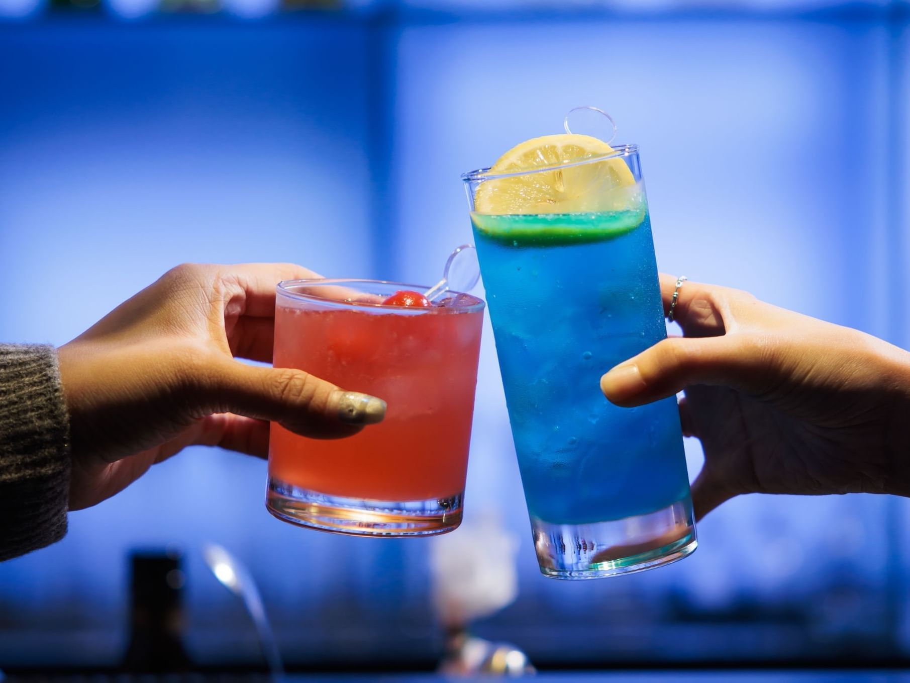 Close-up of friends toasting cocktail glasses at Park Hotel Hong Kong