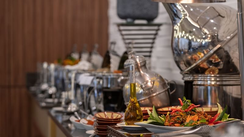 Buffet spread featuring various dishes on decorative plates at Warwick Hotels and Resorts