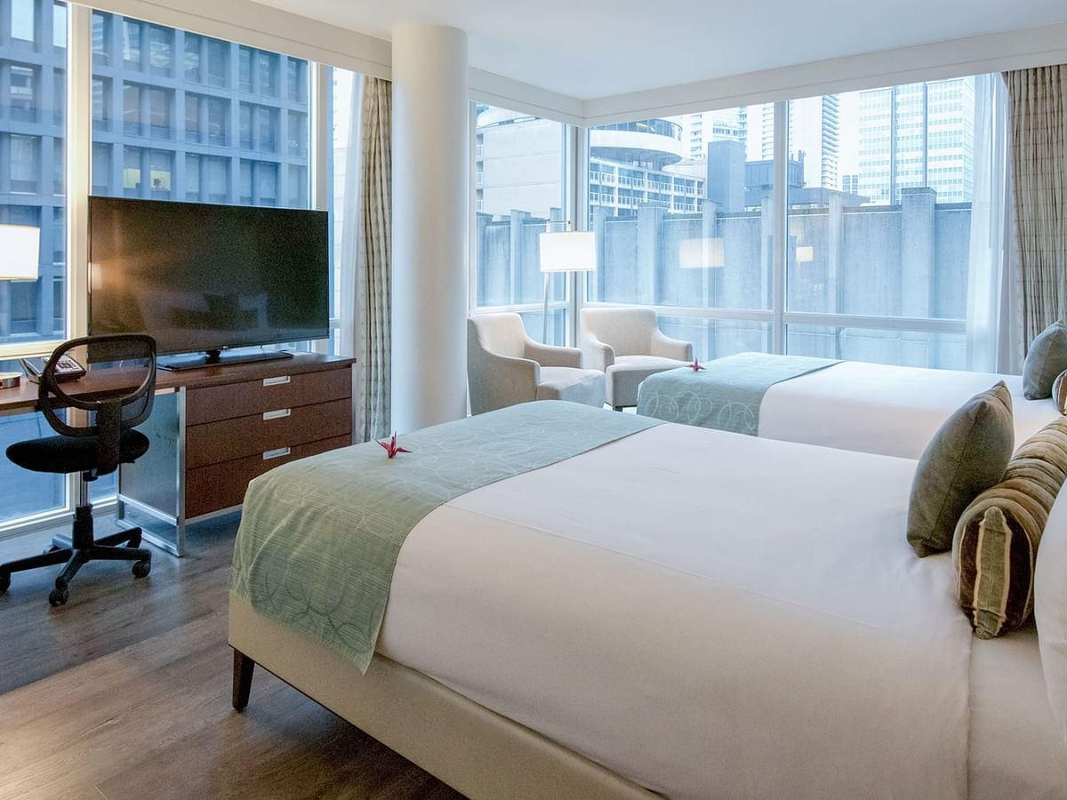 double bed with tv and sofa chair