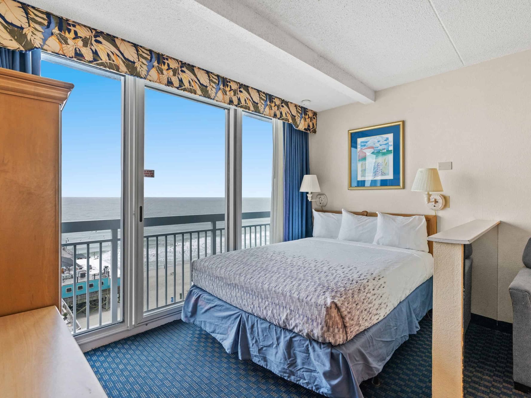 Cozy bed with window in Oceanfront Studio Apartment at The Yachtsman Resort