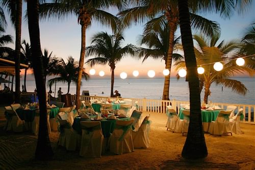 Banquet tables on the beach during sunset at Infinity Bay