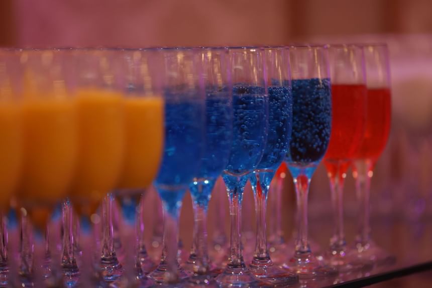 Rows of champagne flutes with colorful drinks served at APA Hotel Woodbridge