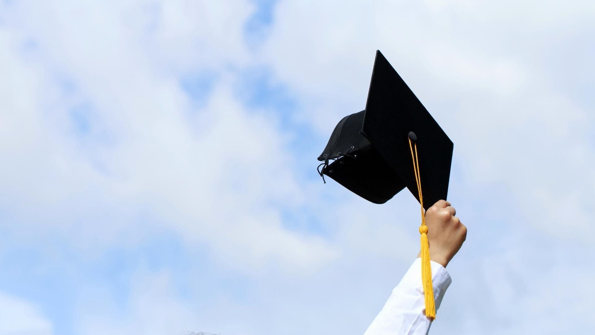 Student holding up graduation hat ready to celebrate at Easthampstead Park, a top Berkshire Graduation Party Venue