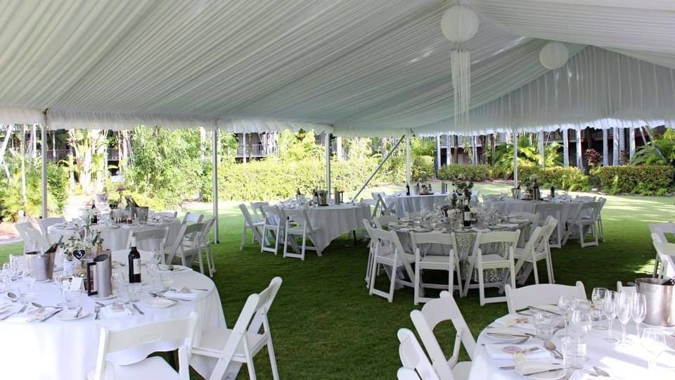 Outdoor event tent with banquet setup circular tables set for dining, in Receptions at Mercure Hotel Townsville