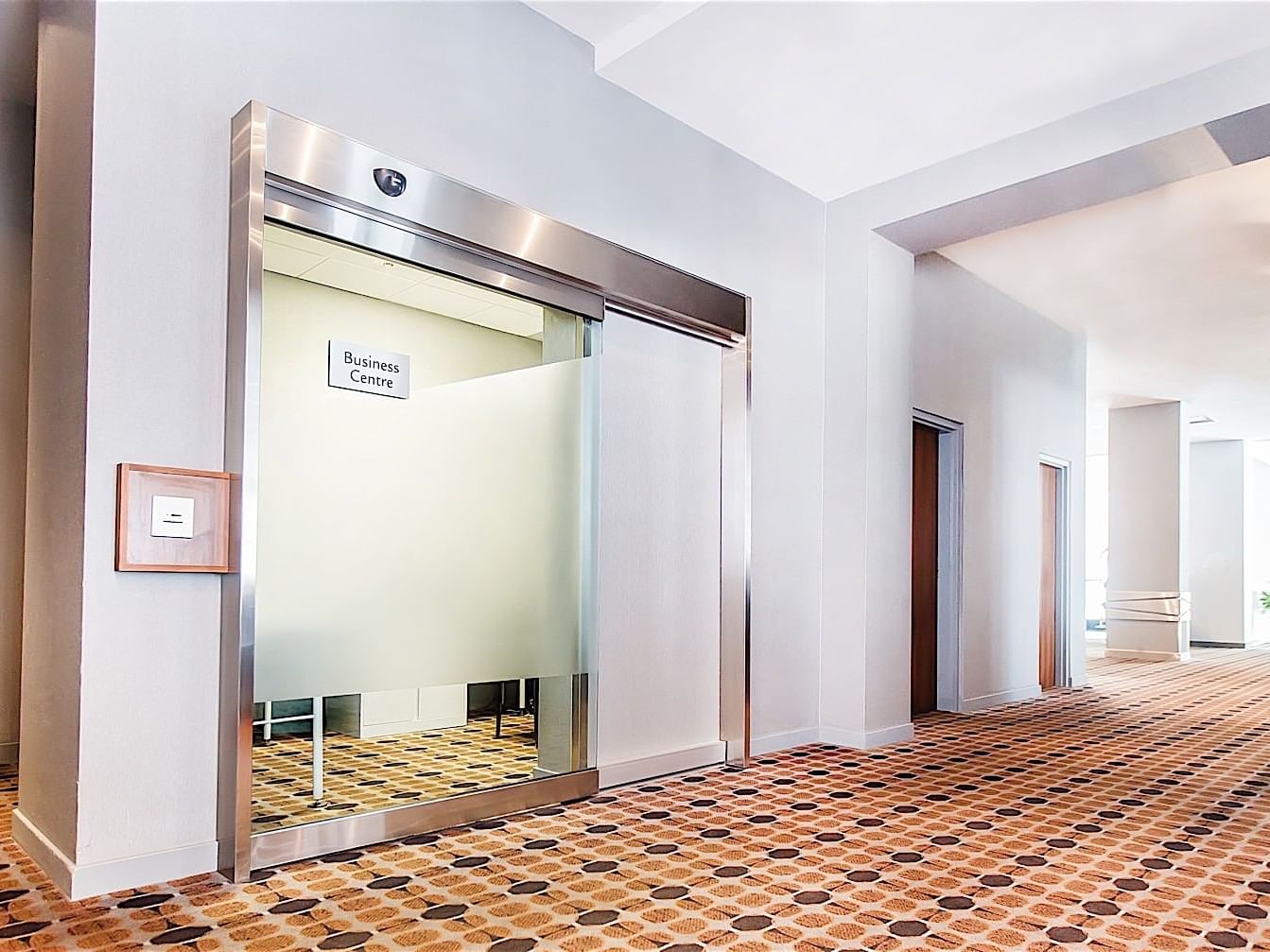 Entrance of business center with a hallway at Matrix Hotel