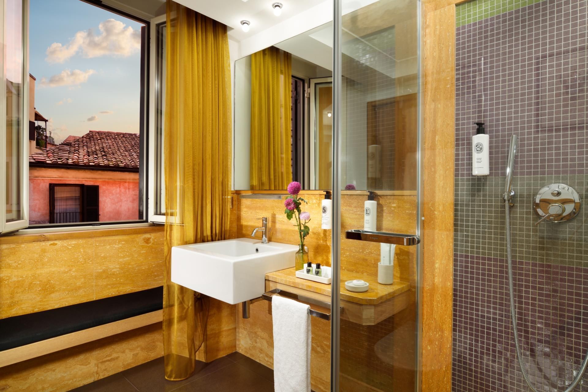 Shower area, wash basin with mirror in bathroom of Moncada Suite at Babuino 181