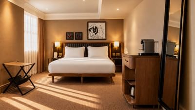 Collection Premium Room with king bed, warm lighting, and modern furnishings at The May Fair Hotel, London, England.