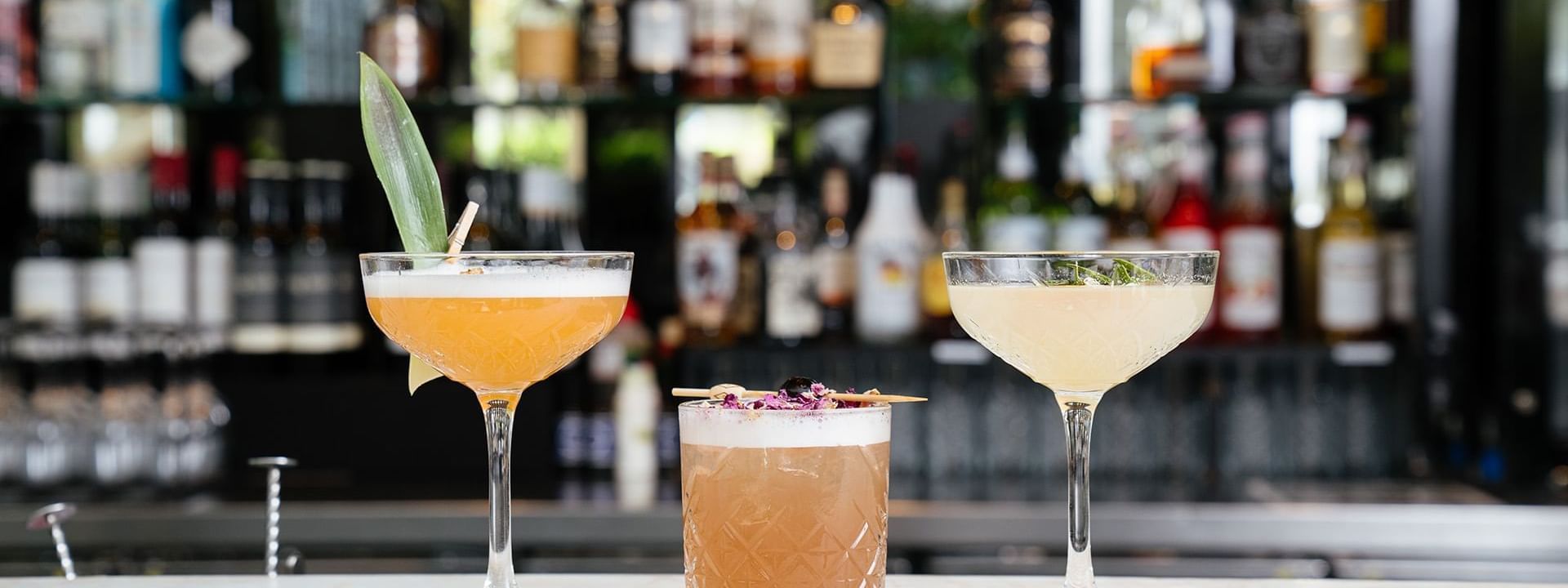 Cocktails on a bar counter with garnishes in Lobby Lounge at Crown Metropol Perth
