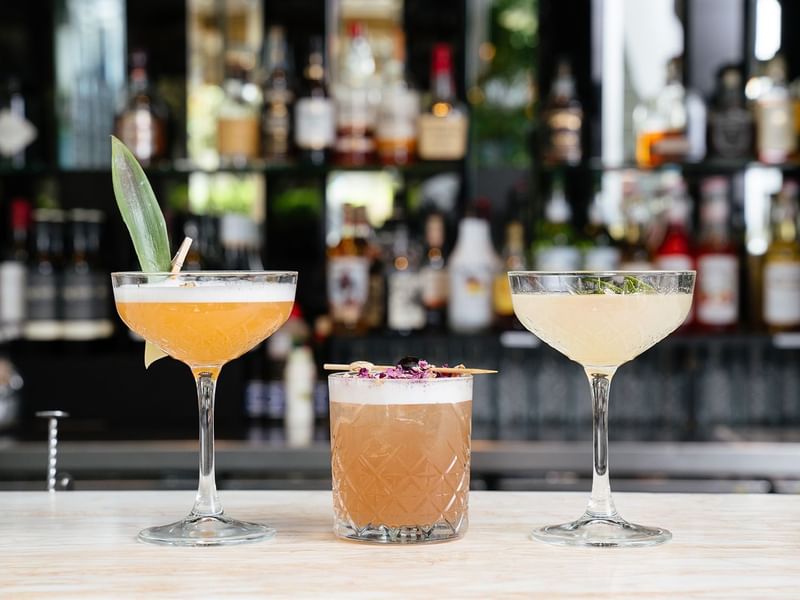 Cocktails on a bar counter with garnishes in Lobby Lounge at Crown Metropol Perth
