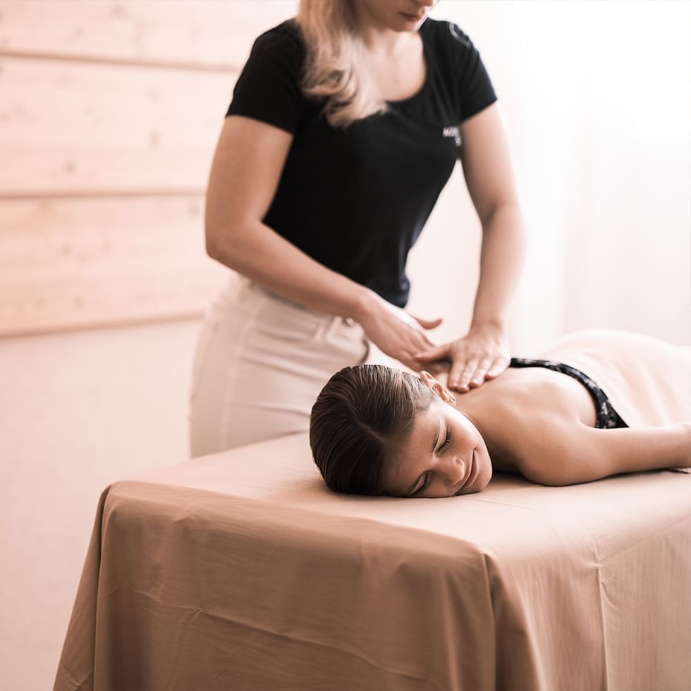 A girl having a back massage at Falkensteiner Hotels