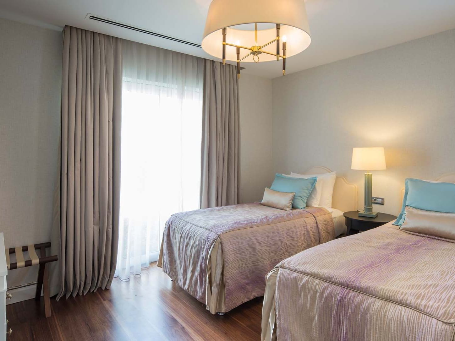 Nightstand by the beds in Superior Villa with wooden floors at Titanic Deluxe Golf Belek