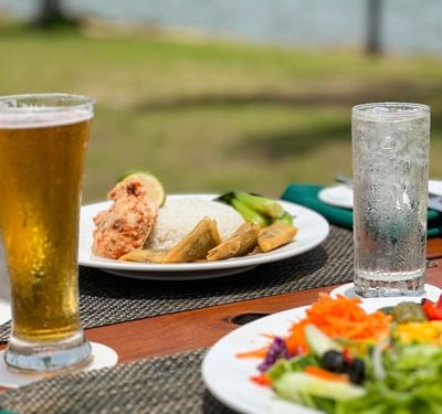 Plates of food and beverages on a table at The Naviti Resort Fiji Coral Coast
