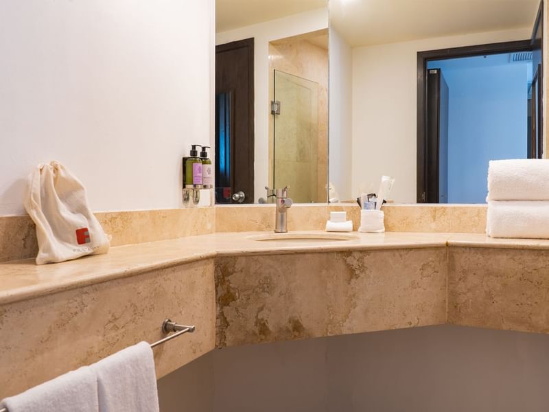 Bathroom with large mirror and sink in Prime suite at Fiesta Inn